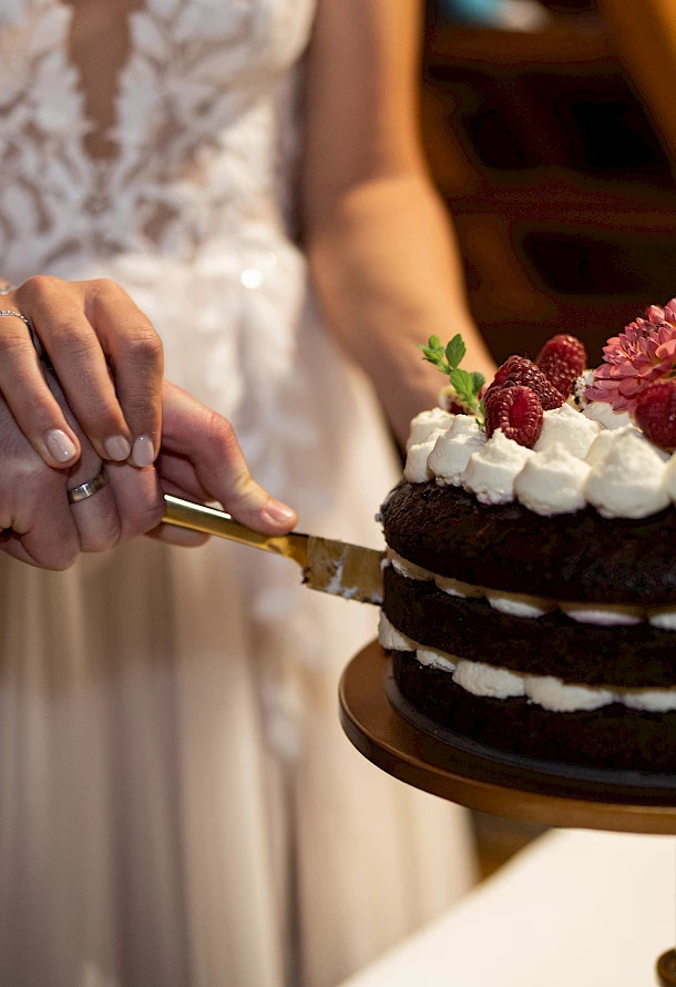 Detailaufnahme der Hochzeitstorte beim Anschnitt vom Brautpaar Festscheune Hermannsfeld